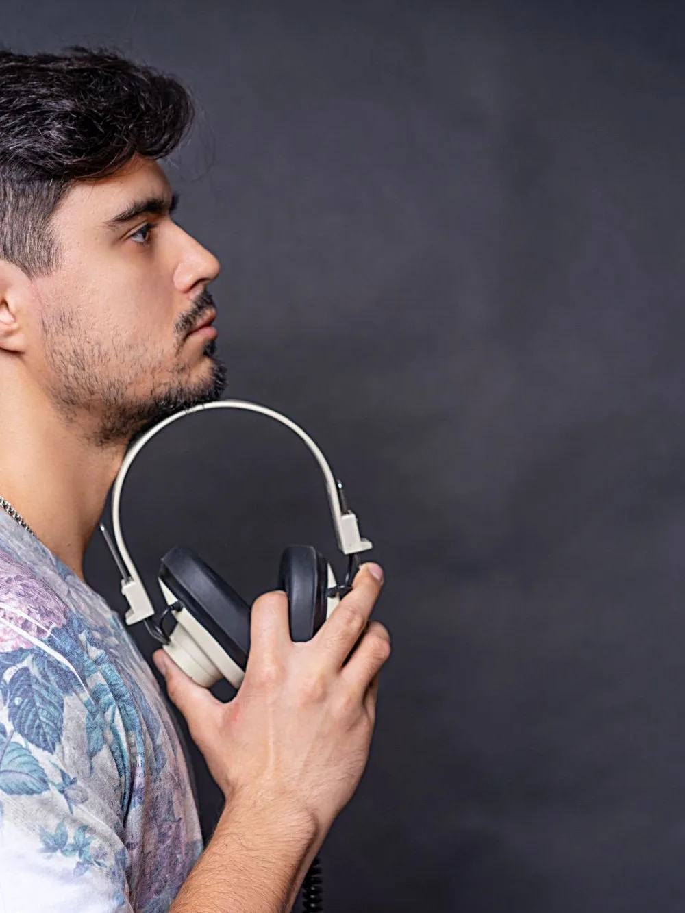 A man holding his headphones in the studio