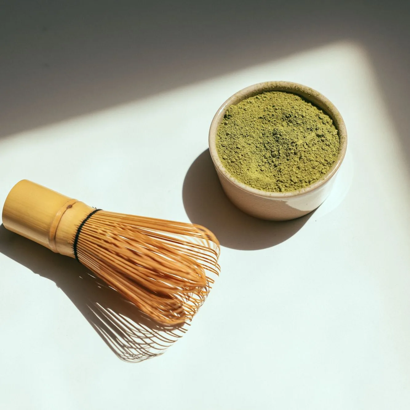Matcha in a bowl with a whisk