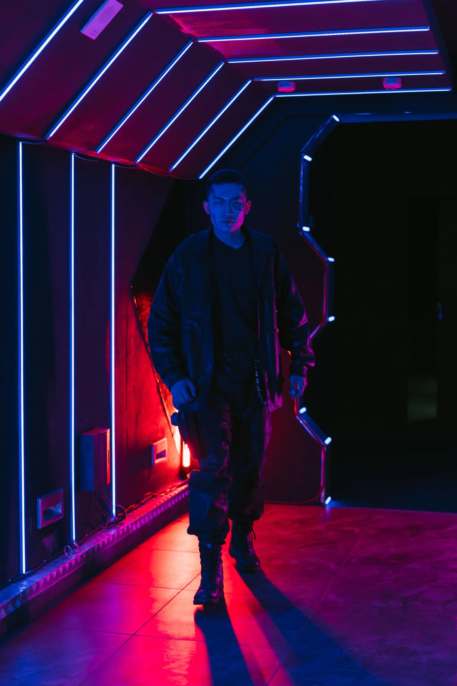 The field jacket in a neon corridor