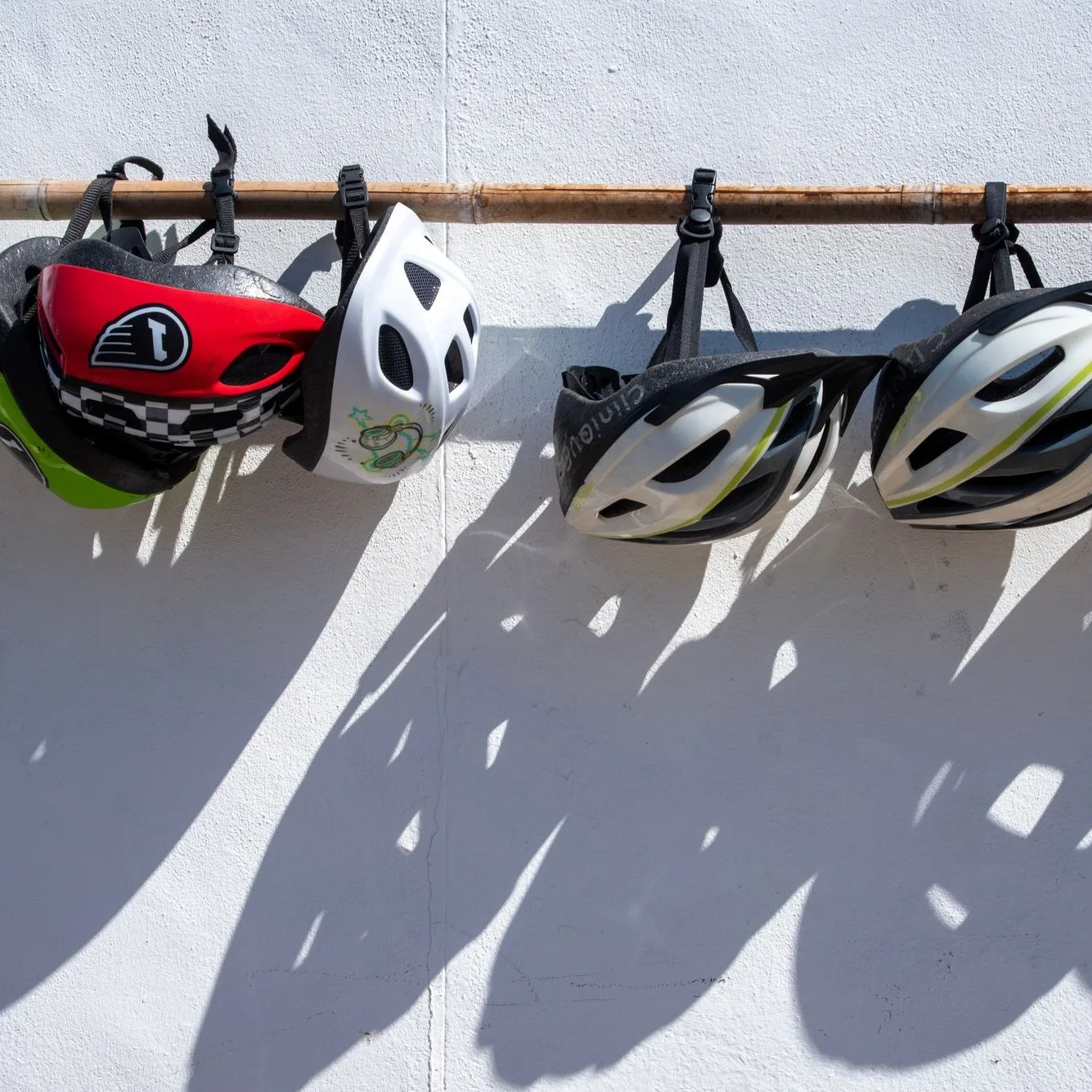 Helmets hanging on a white wall