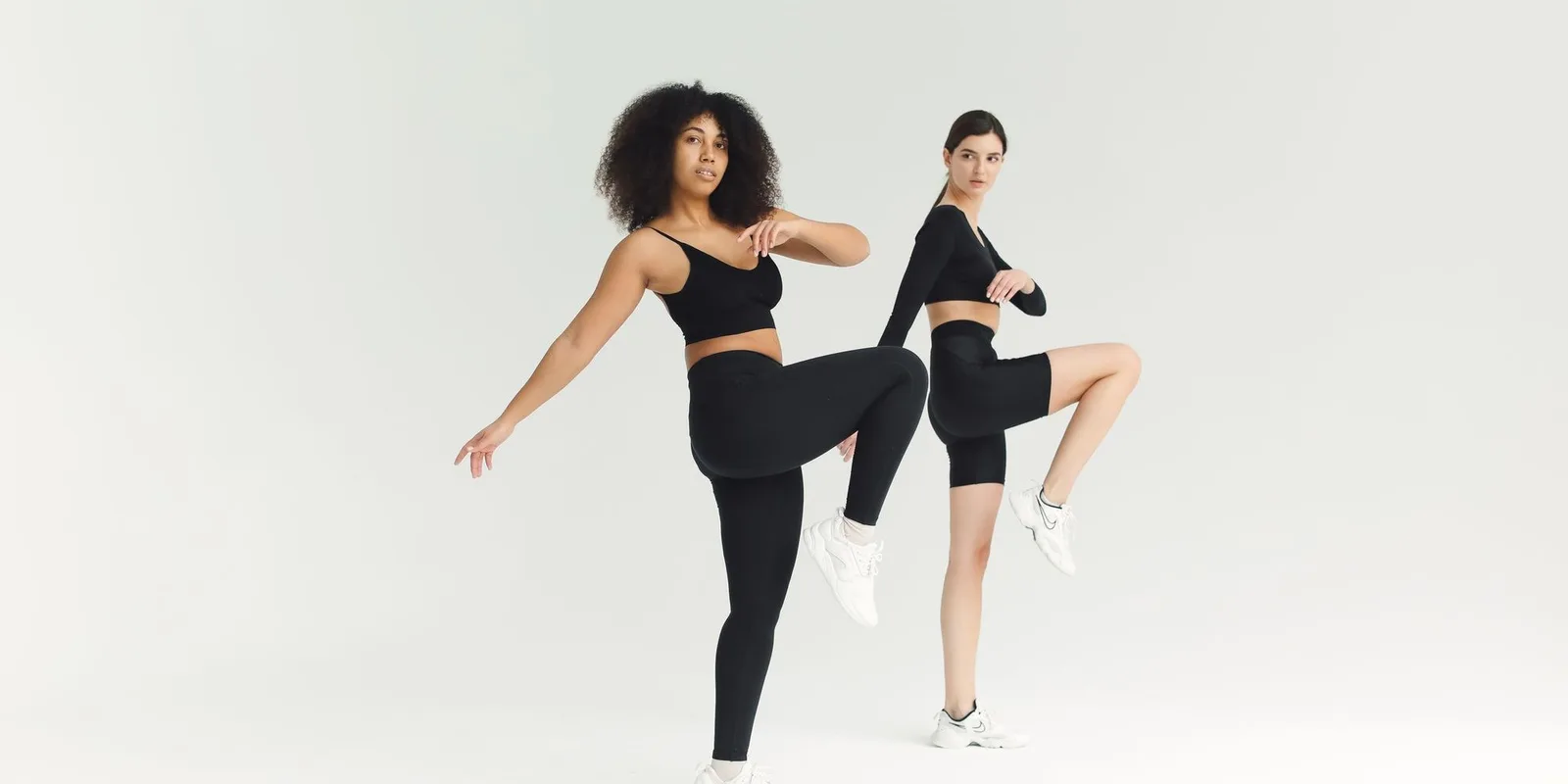 Two women training in a bright studio