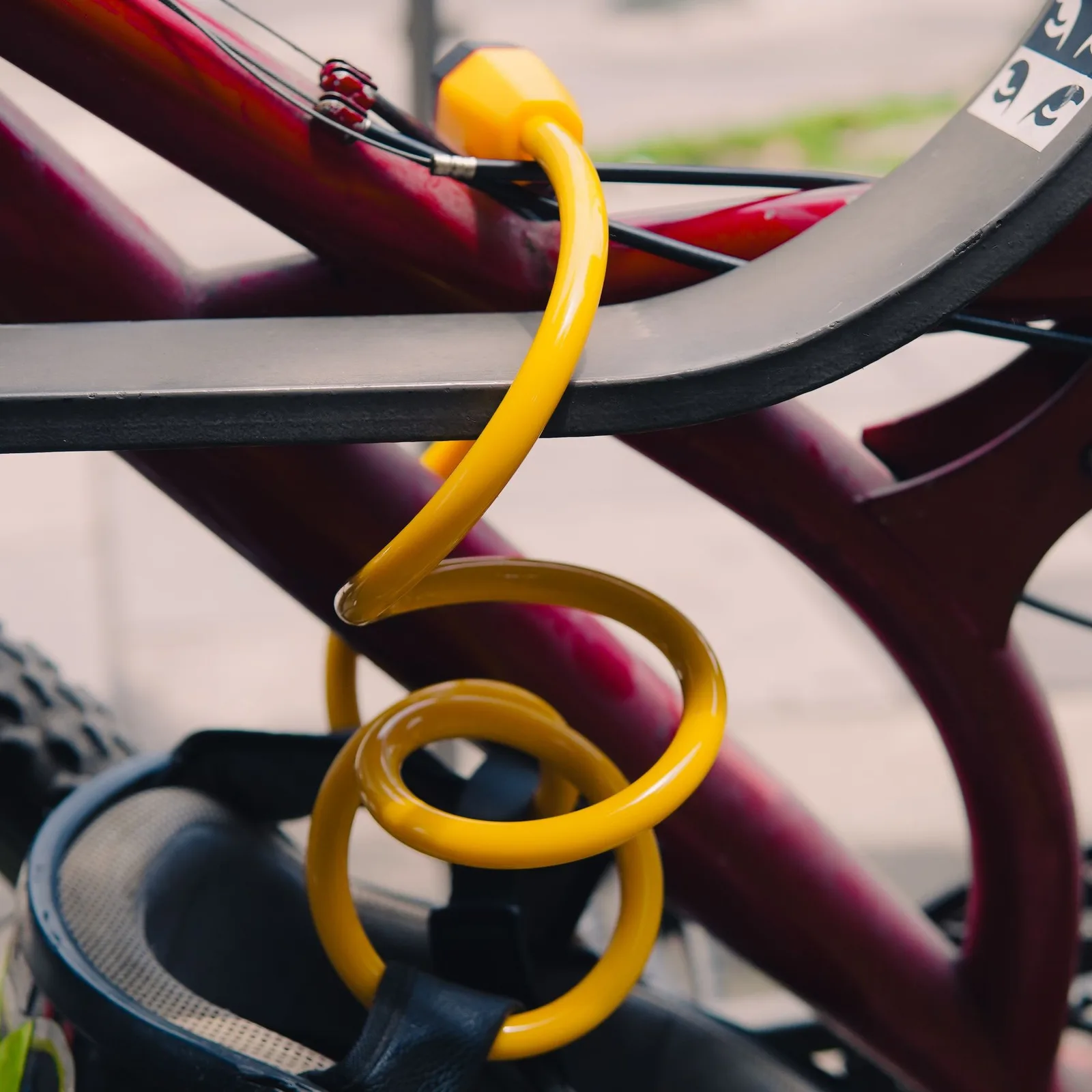 Yellow cable lock on a bike rack