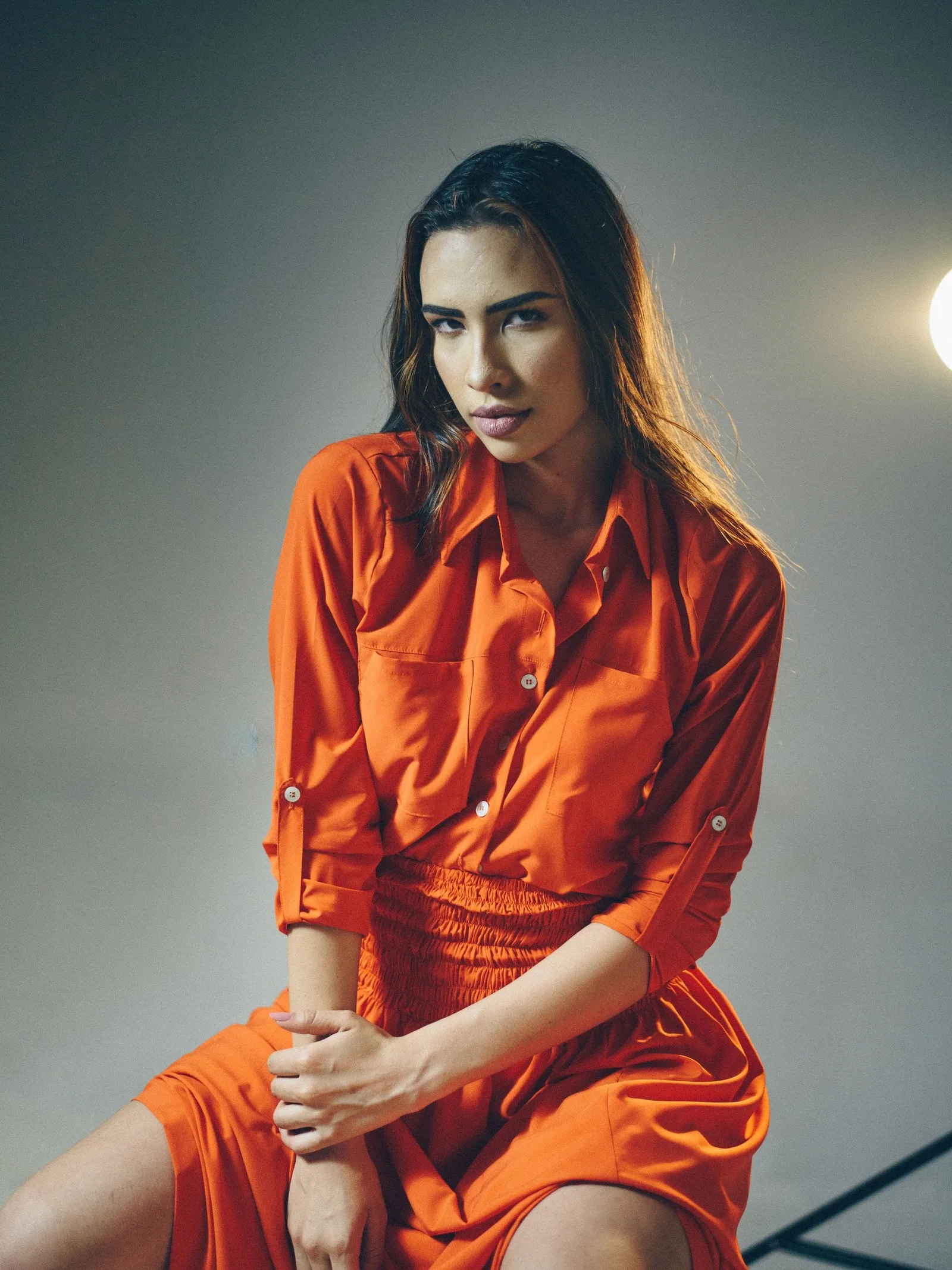 A woman in a rust cotton shirt dress
