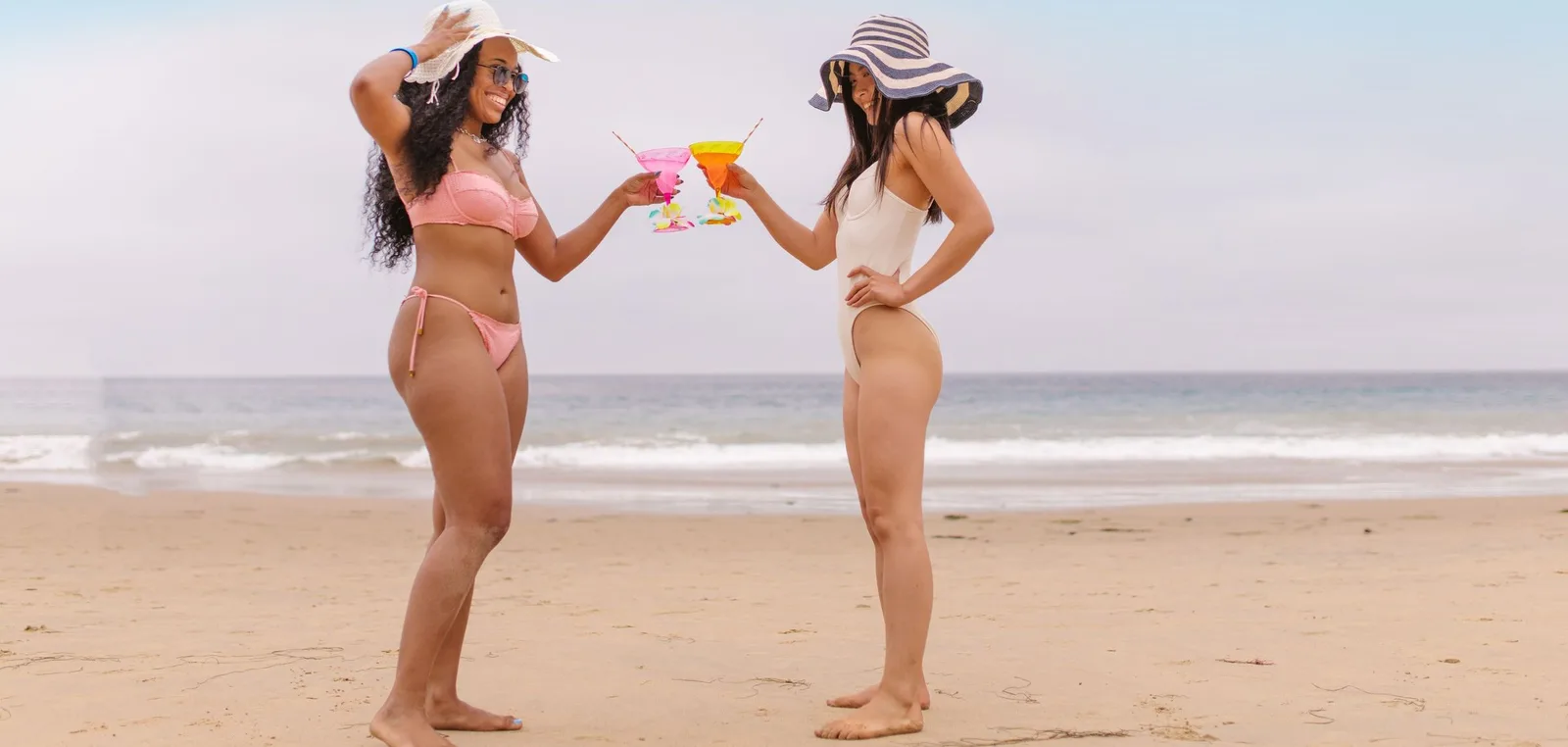 Three friends in swimsuits by the sea
