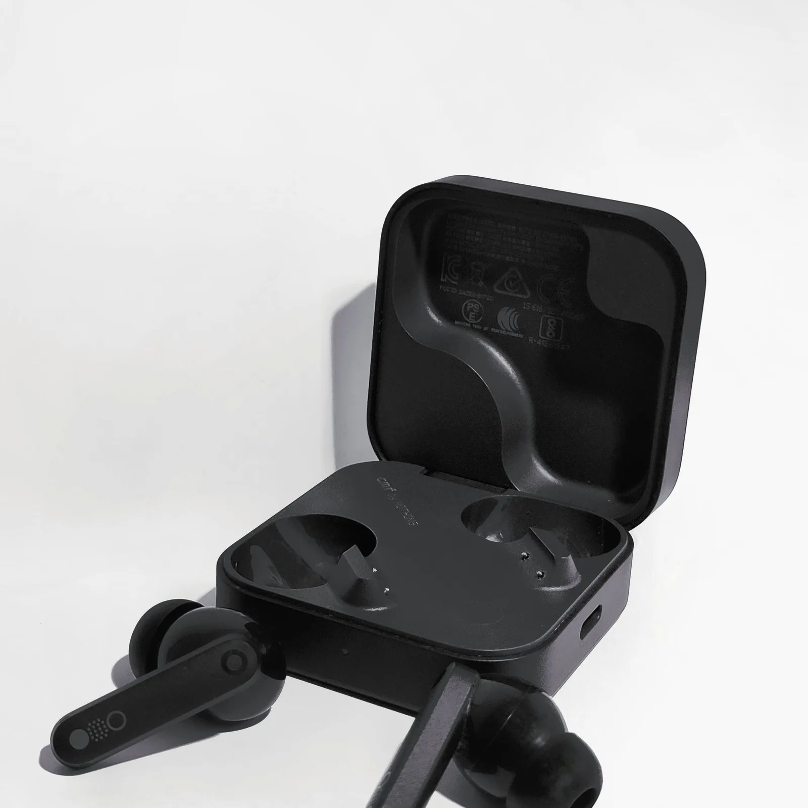 Black earphones in their open case