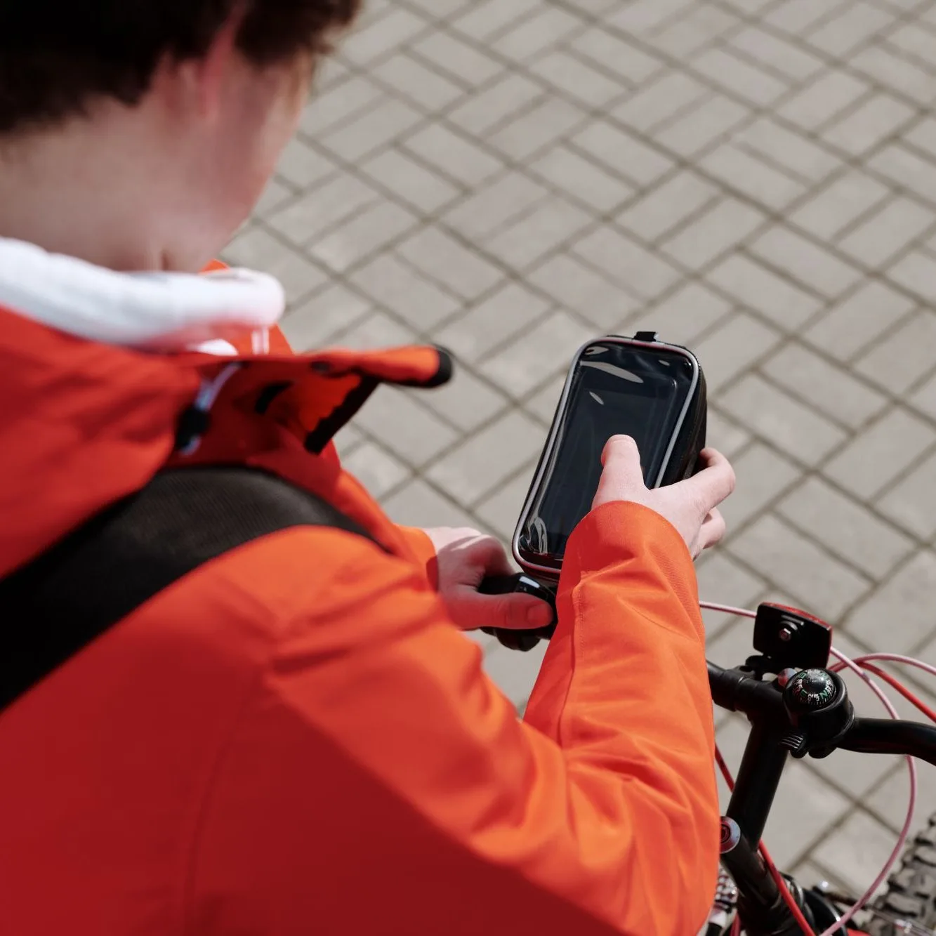 Rider checking a phone in a handlebar mount
