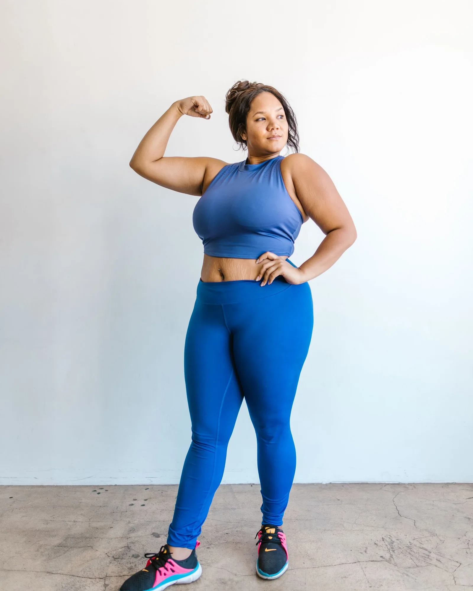 A woman in black leggings and a crop top