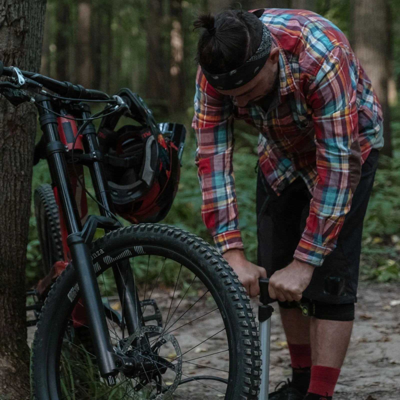 Rider pumping a tyre in the forest