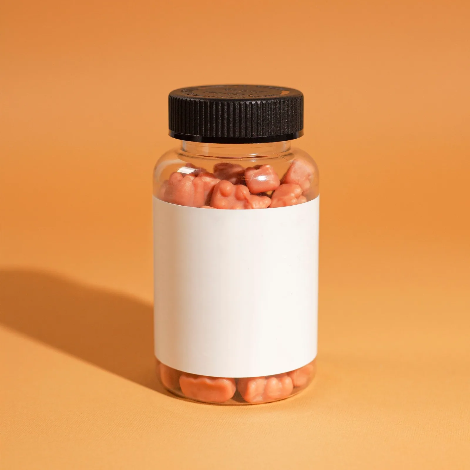 Jar of gummies on orange