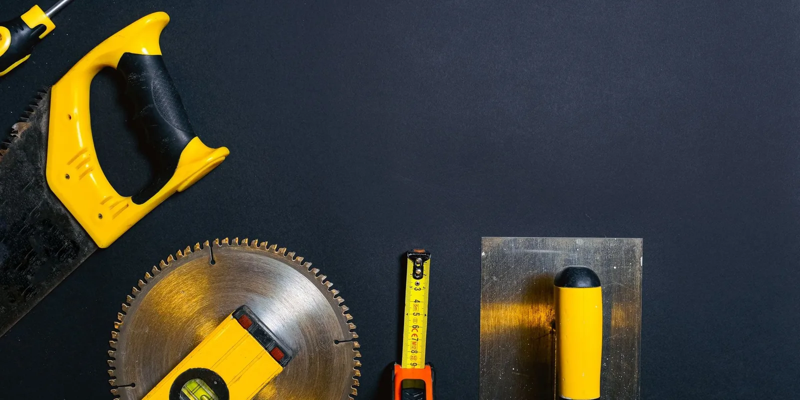 Power tools, a hammer and paint on a workshop floor
