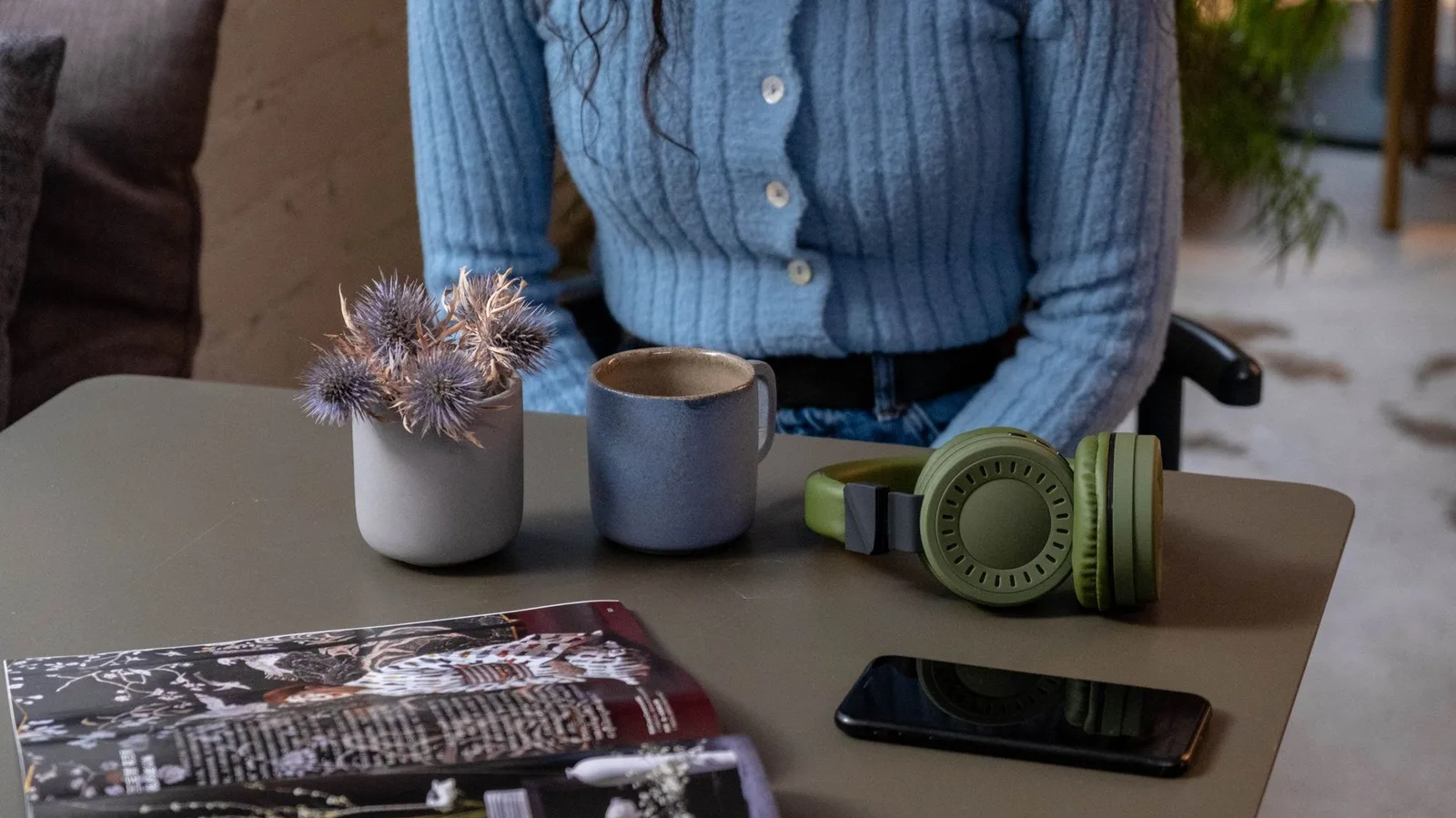 Headphones, a phone and a speaker on a desk