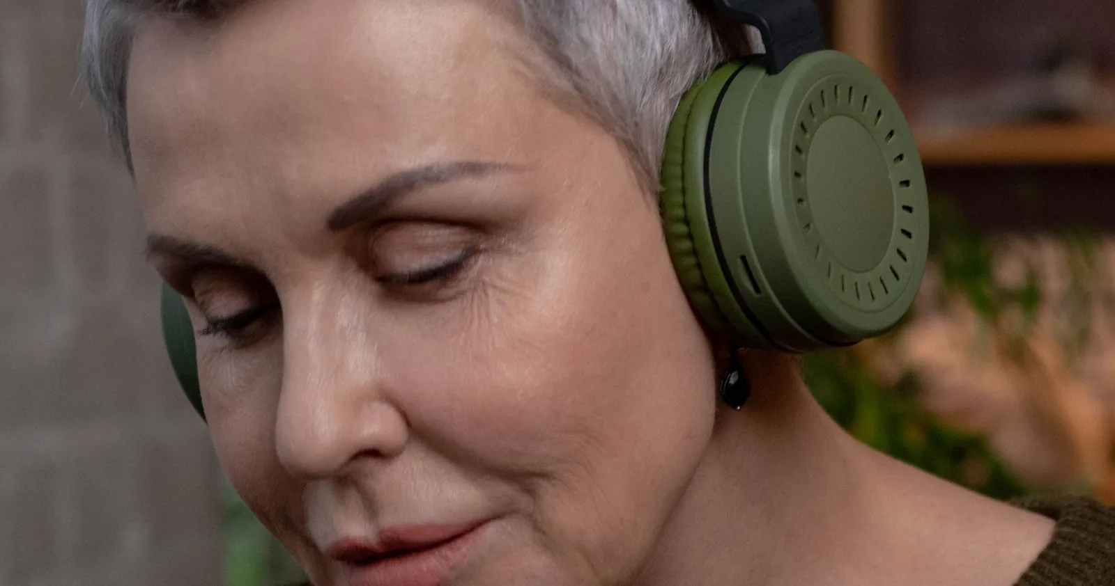 A woman listening with sage headphones