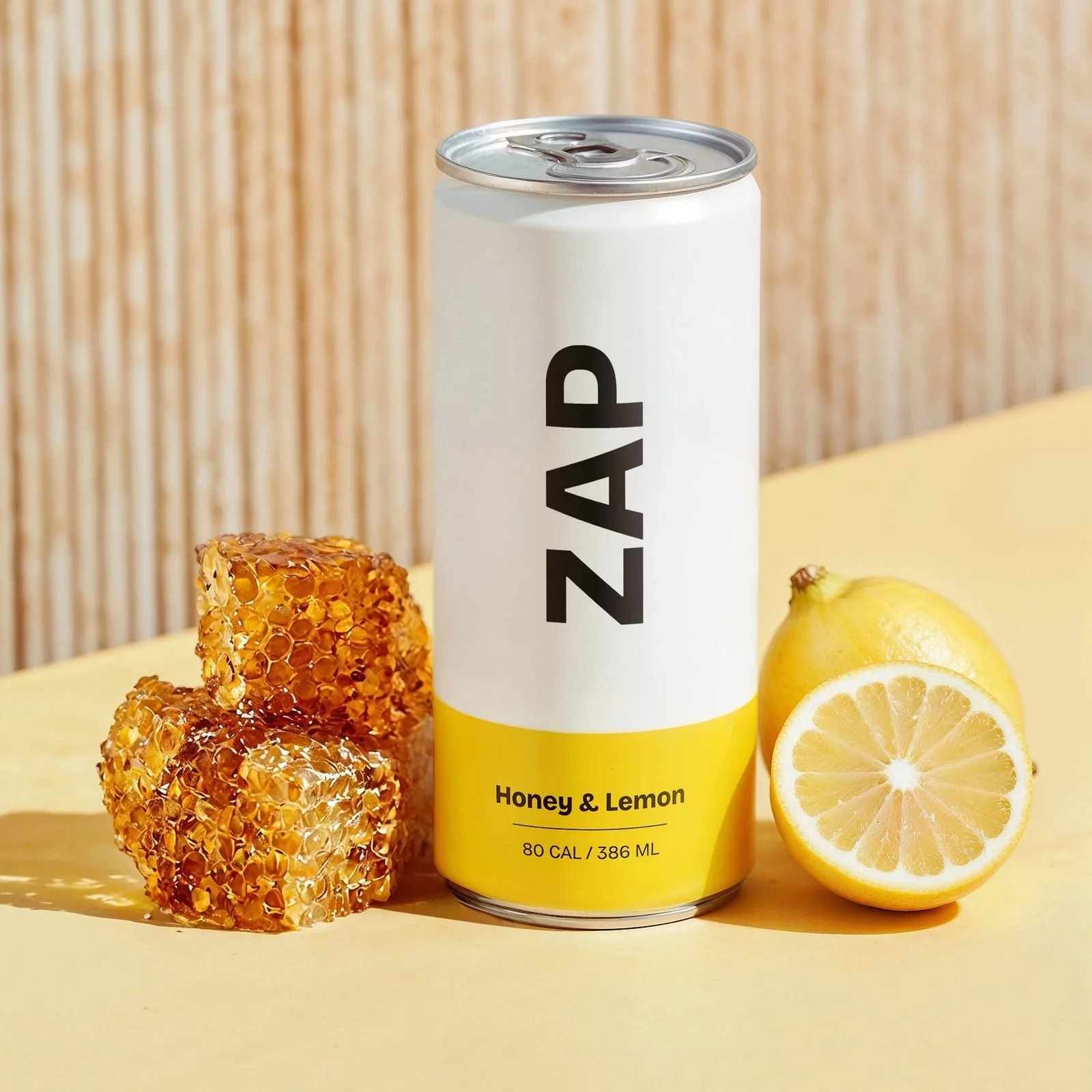 A can of honey lemon beside honeycomb