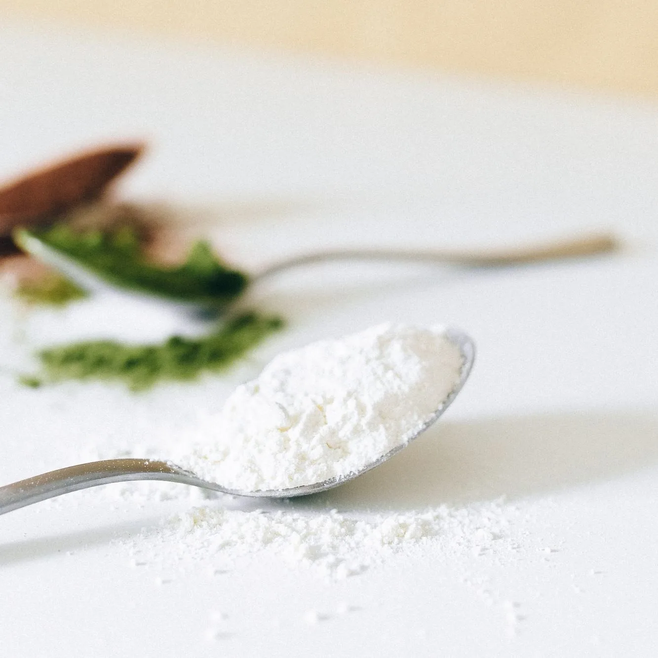 Spoons of powder on white